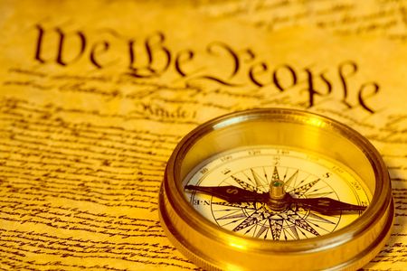 Antique compass and first words of United States Constitution