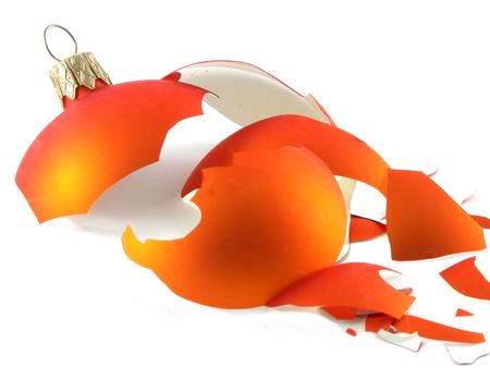 Orange broken glass ball on the light background.