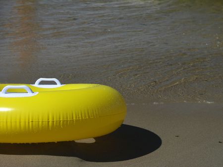 Yellow lifebelt on the seashore.