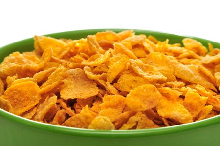 Cornflakes in the green bowl isolated on the white background.