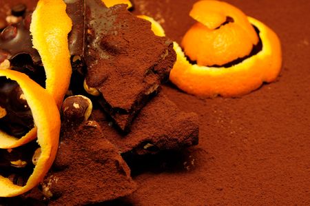 Chocolate with nuts on the cocoa background.の写真素材