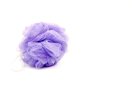 Violet bath sponge on white background.の写真素材