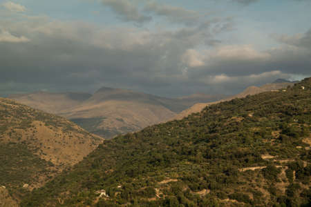landscape mountains trees sky cloudsの写真素材