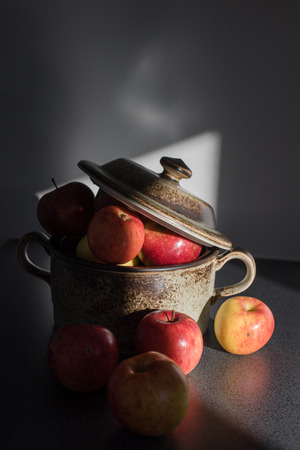 Fresh apples in the clay pot.の写真素材