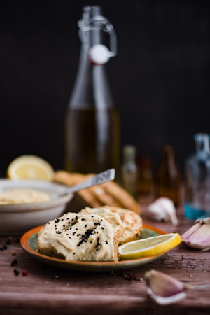 The hummus on a bread and ingredients.の写真素材