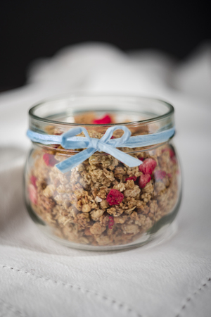Granola in jar with blue ribbon.の写真素材