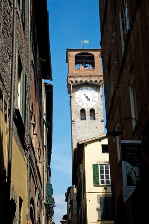 Typical Italian street with tower and clockの写真素材