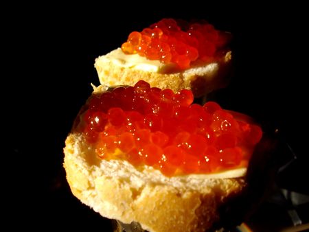 open sandwiches with red caviar in morning illuminationの写真素材