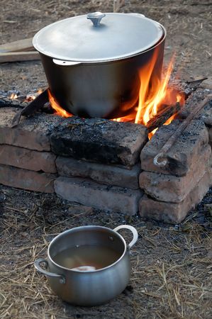 preparation of soup from fresh river fish, morning illuminationの写真素材