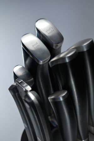 set of kitchen knives on a light background, studio light