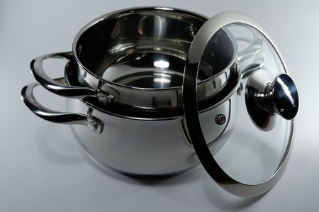 steel pan for preparation of soups and other dishes, light backgroundの写真素材