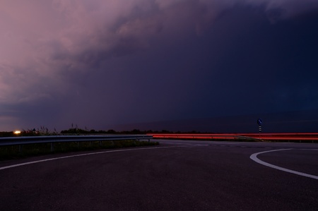 approaching thunderstorm with rain in the evening motorwayの写真素材