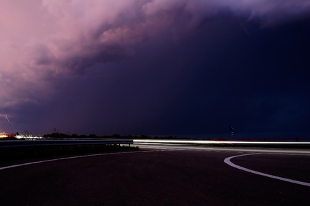 approaching thunderstorm with rain in the evening motorwayの写真素材
