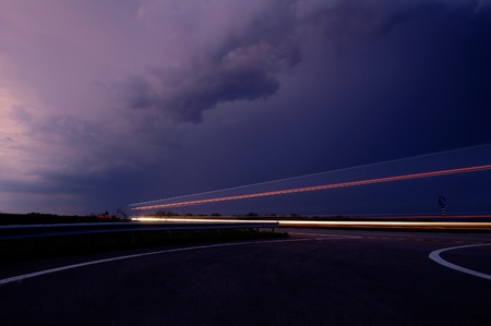 approaching thunderstorm with rain in the evening motorwayの写真素材