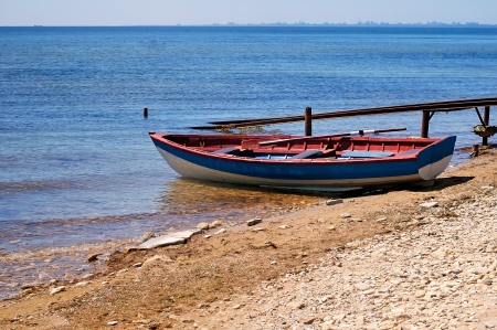 red and blue wooden boat for sea fishingの写真素材