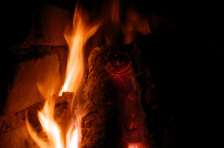 Flames of fire from the wood in a brick fireplaceの写真素材
