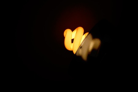spiral fluorescent light bulb, on a darken backgroundの写真素材