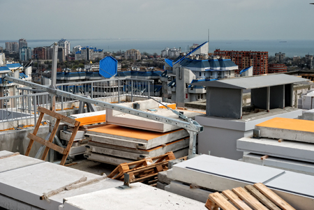 Construction site on a high-rise building with concrete slabs in the foregroundの写真素材
