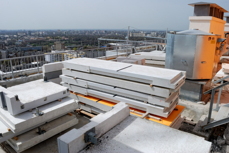 Construction site on a high-rise building with concrete slabs in the foregroundの写真素材