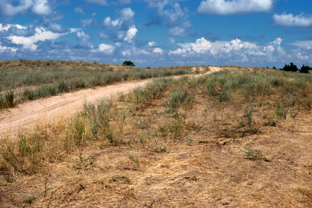 sandy road through a deserted hillの写真素材