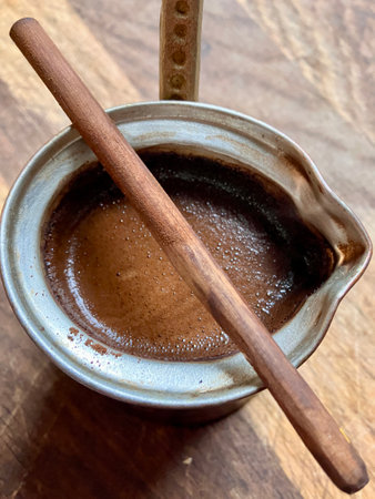 Aromatic Turkish coffee in a copper cezve with rich foam.の写真素材