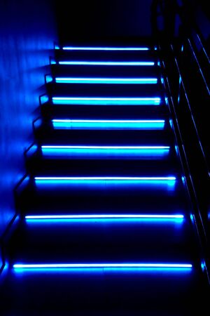 Neon background. Dark blue stairs. Night club, bar, quest, concert.の写真素材