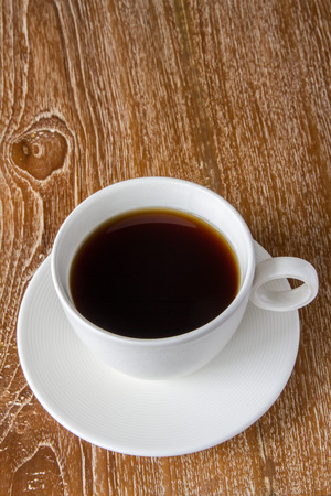 White cup of coffee on wooden tableの写真素材