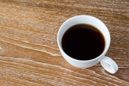 White cup of coffee on wooden tableの写真素材