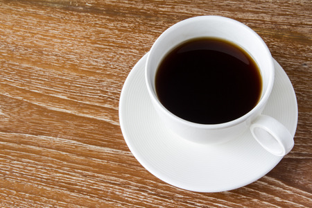 White cup of coffee on wooden tableの写真素材