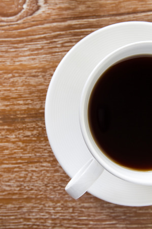 White cup of coffee on wooden tableの写真素材