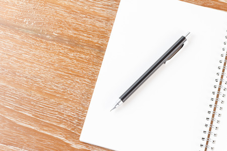 notebook and pencil on wooden backgroundの写真素材