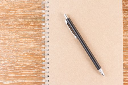 notebook and pencil on wooden backgroundの写真素材