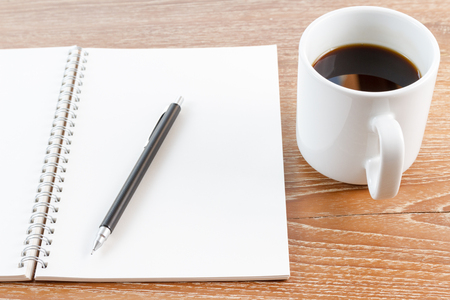 notebook and coffee on wooden backgroundの写真素材