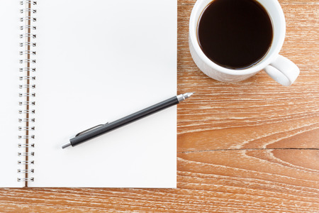 notebook and coffee on wooden backgroundの写真素材