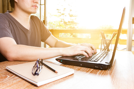 man using laptop computer on table, home office conceptの写真素材