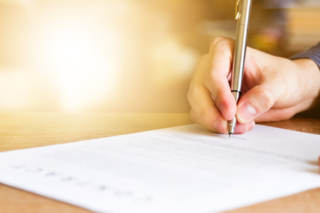 business man signing contract document on office desk