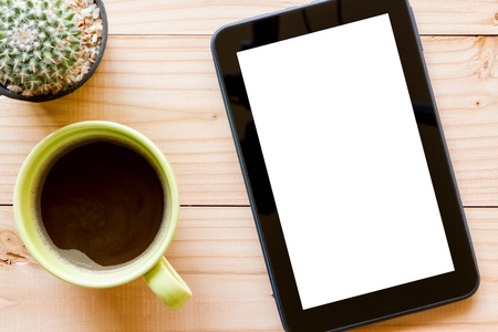 tablet computer with blank white screen on wooden background, top view