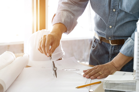 architect working and sketching architectural drawing plan on table in officeの写真素材