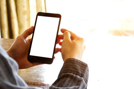 business man hand using mobile phone on table