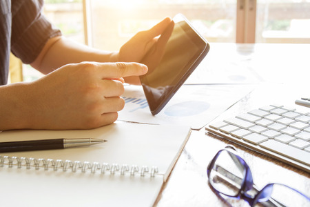 business man working with digital tablet computer at office table - business concept