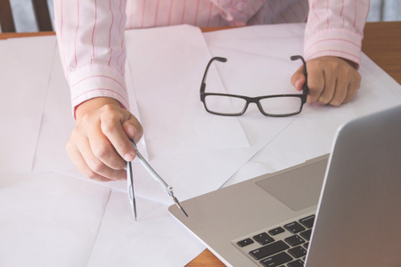 architect working and sketching architectural drawing plan on table in office