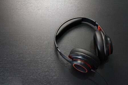 black headphones on black table or background. flat lay. table top view. copy space. - musical...