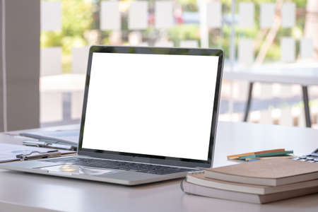 modern office workspace desk with blank screen laptop computer and office supplies. - business...