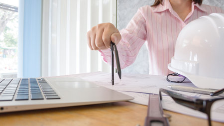 architect working and sketching architectural drawing plan on table in officeの写真素材