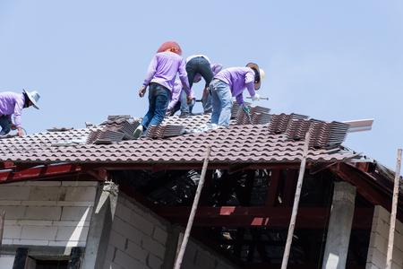 PHIMAI, THAILAND - FEBRUARY 24, 2016: Man working on roof in site construction PHIMAI NAKHONRATCHASIMA THAILAND.のeditorial素材