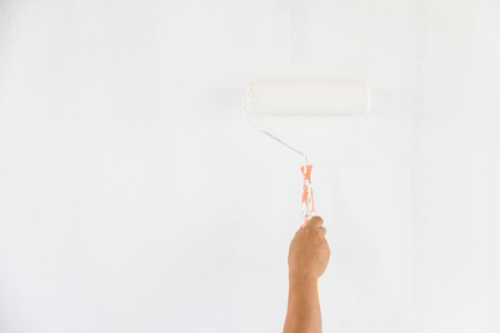 Painting wall with paint roller white colorの写真素材