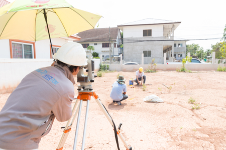 NAKHONRATCHASIMA, THAILAND - MAY 3, 2016: Man survey checking before housing construction site NAKHONRATCHASIMA THAILAND.のeditorial素材
