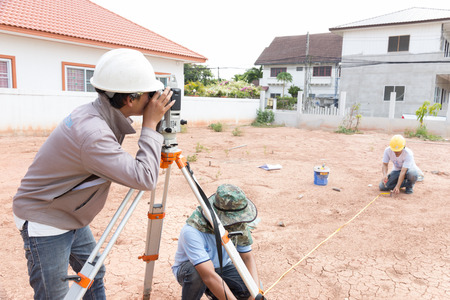 NAKHONRATCHASIMA, THAILAND - MAY 3, 2016: Man survey checking before housing construction site NAKHONRATCHASIMA THAILAND.のeditorial素材