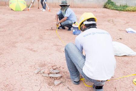 NAKHONRATCHASIMA, THAILAND - MAY 3, 2016: Man survey checking before housing construction site NAKHONRATCHASIMA THAILAND.のeditorial素材