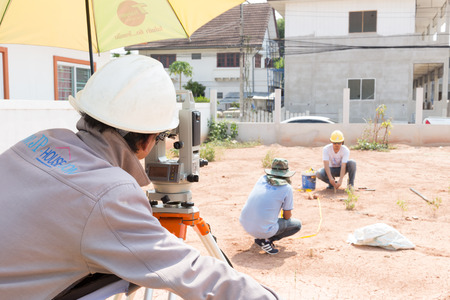 NAKHONRATCHASIMA, THAILAND - MAY 3, 2016: Man survey checking before housing construction site NAKHONRATCHASIMA THAILAND.のeditorial素材